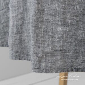 Simple hemmed round tablecloth in dark grey and white melange colors