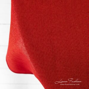 Round red linen tablecloth Donna with gold lurex yarns.