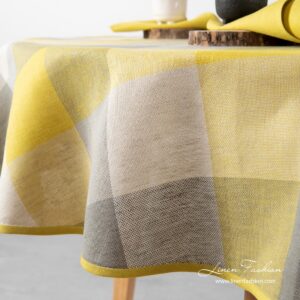 Close view of yellow grey checked oval linen tablecloth - Linen Fashion.