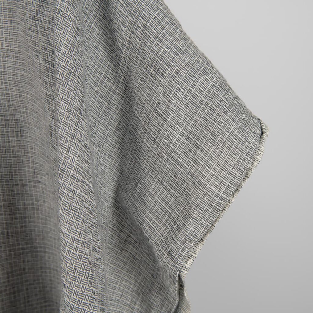 Linen fabric washed dark grey colour close up edge view