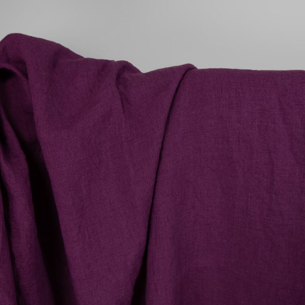 Washed linen fabric in red-violet, plain weave