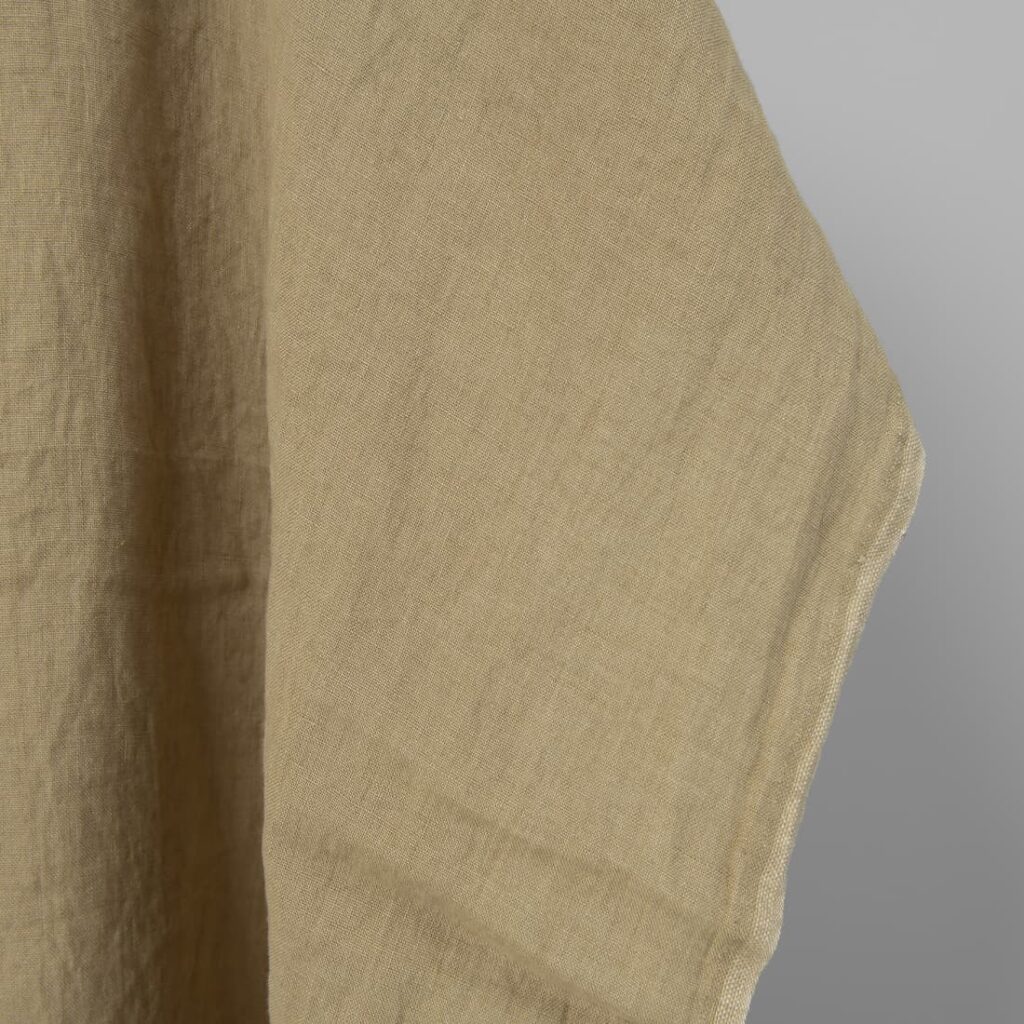 Washed linen fabric in greenish-beige, fabric edge