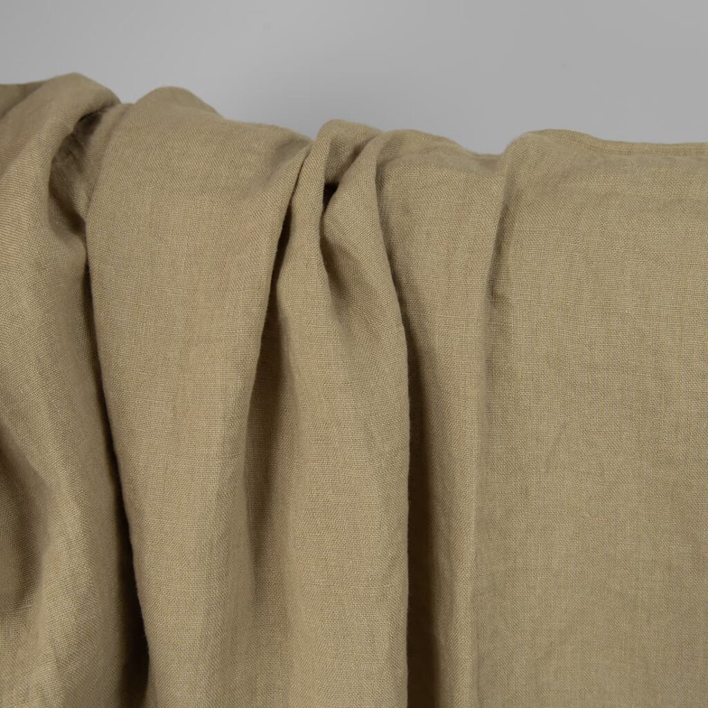 Washed linen fabric in greenish-beige, texture