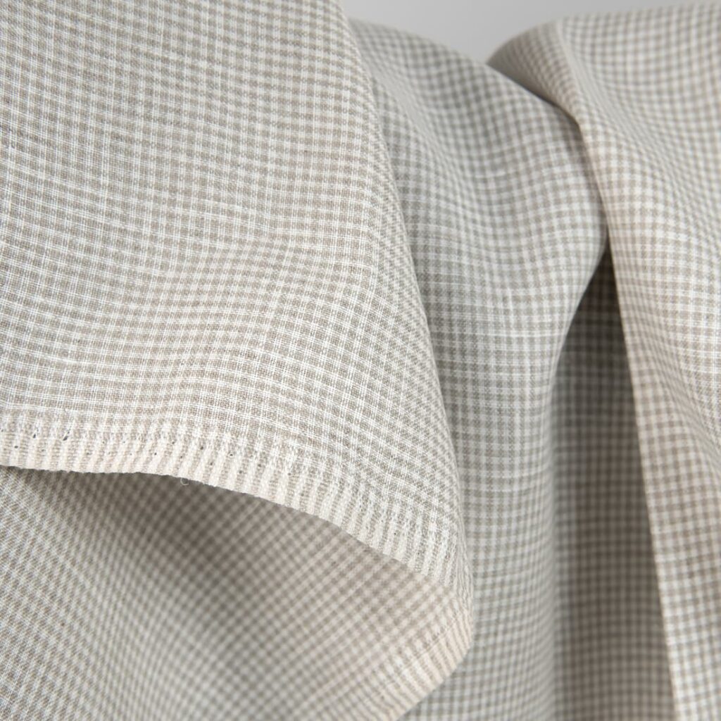 Linen fabric in natural and white colour checks close up detail view