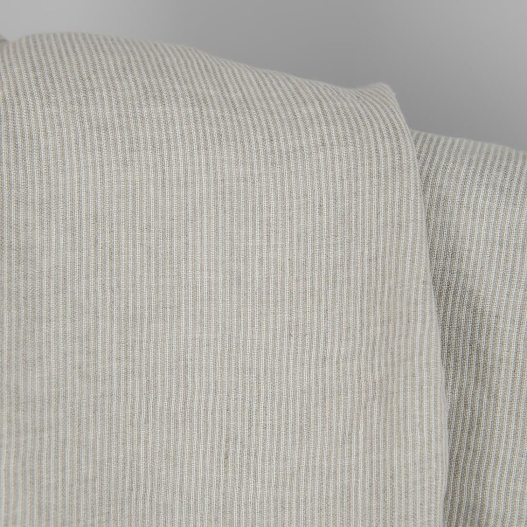 Washed linen fabric in natural and white colour stripes close detail view