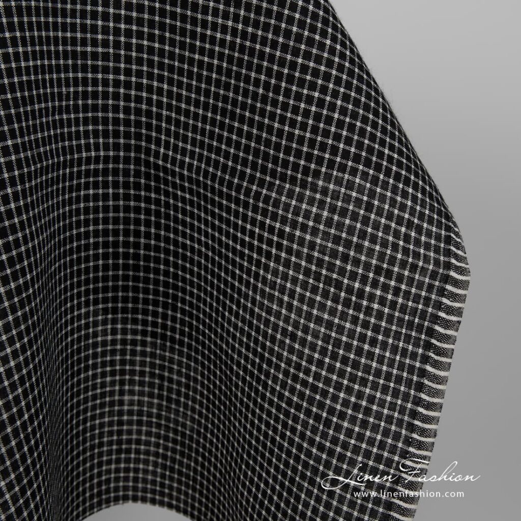 Black linen fabric with white checks close up edge view