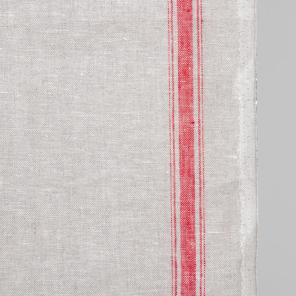 Narrow linen fabric light grey colour with red stripes close up edge
