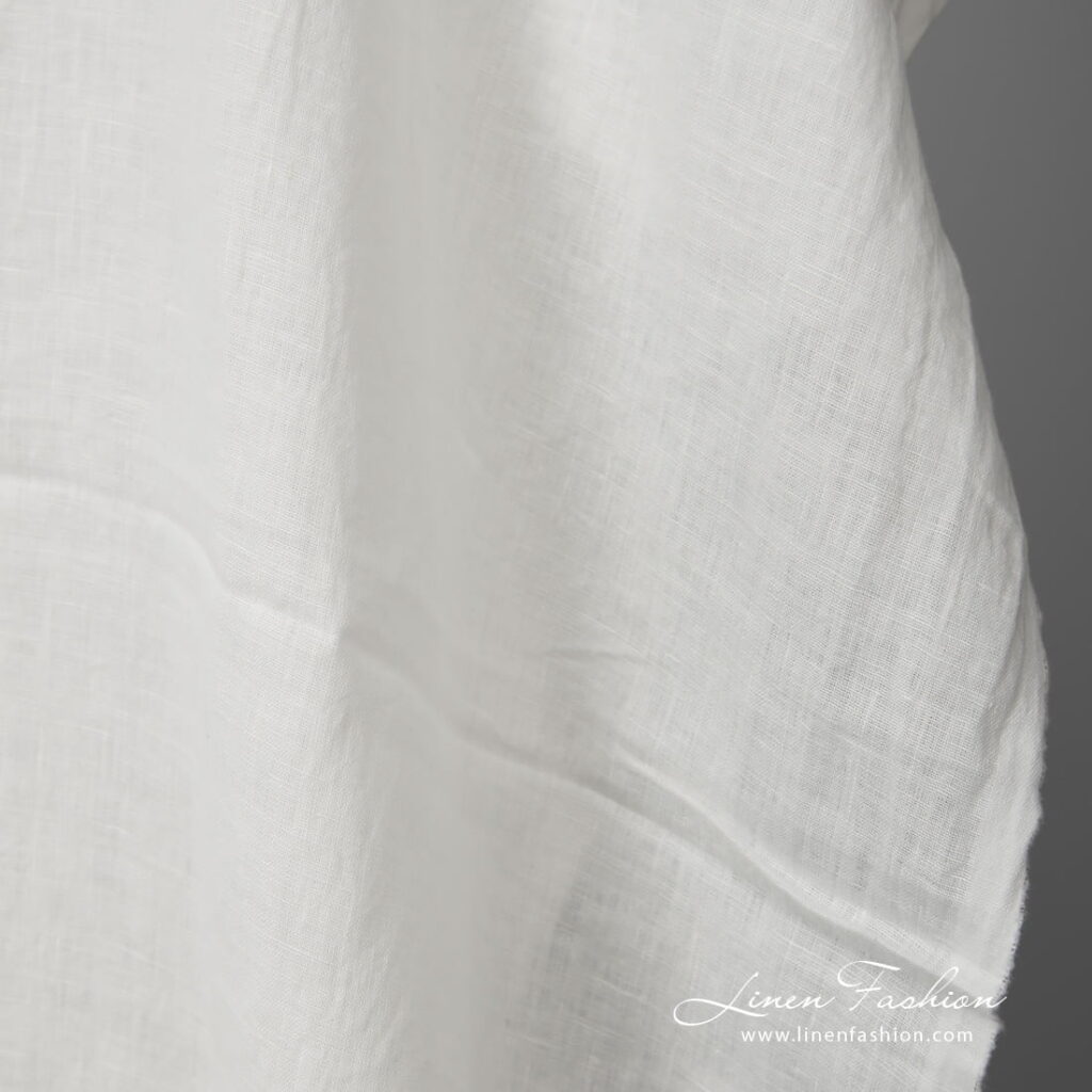 Lightweight washed linen fabric white colour close up view