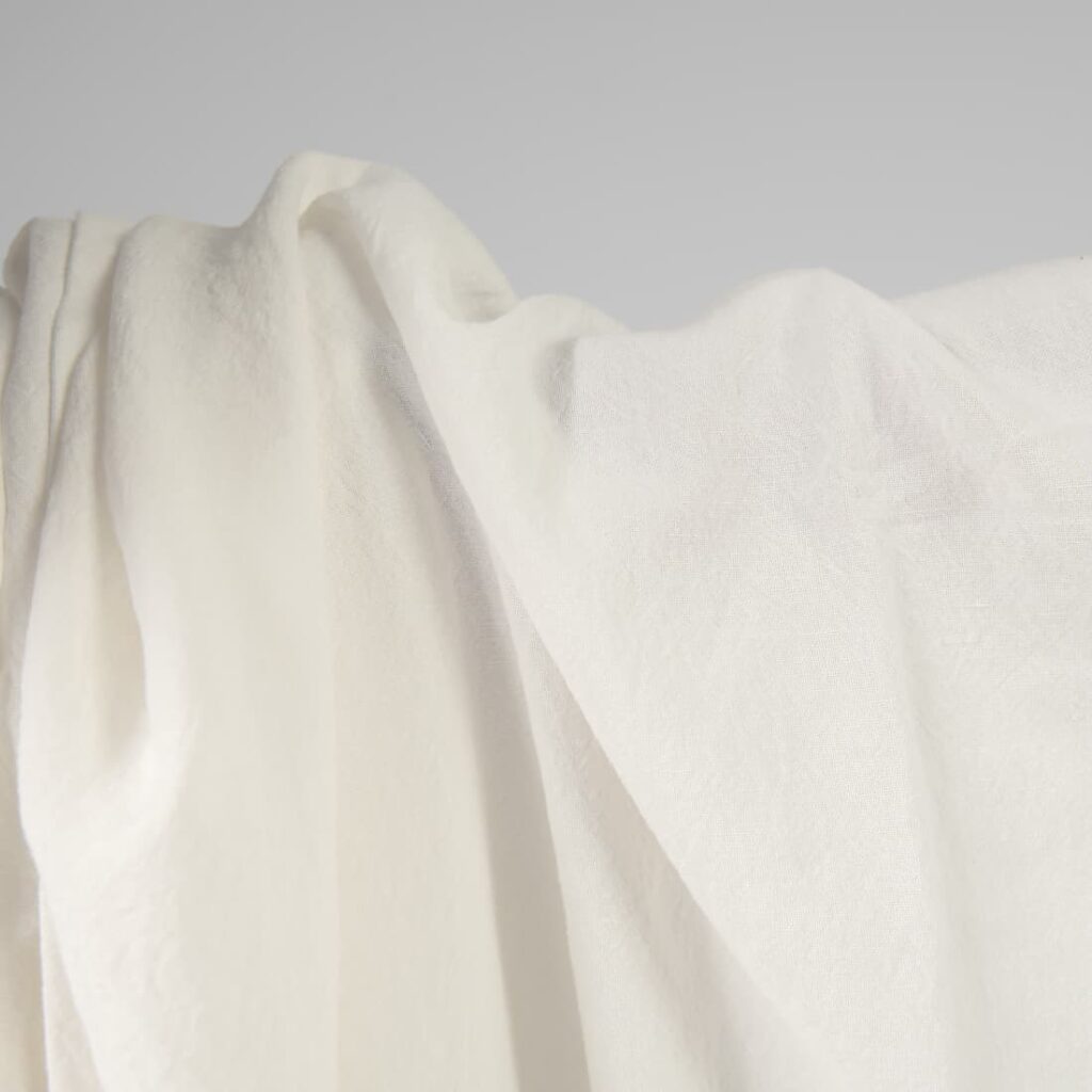 Wide washed linen cotton fabric off-white colour close up detail