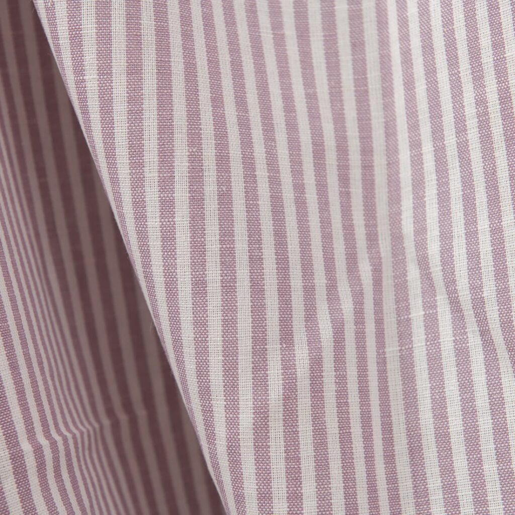 Wide linen cotton fabric in white and lilac stripes close up detail