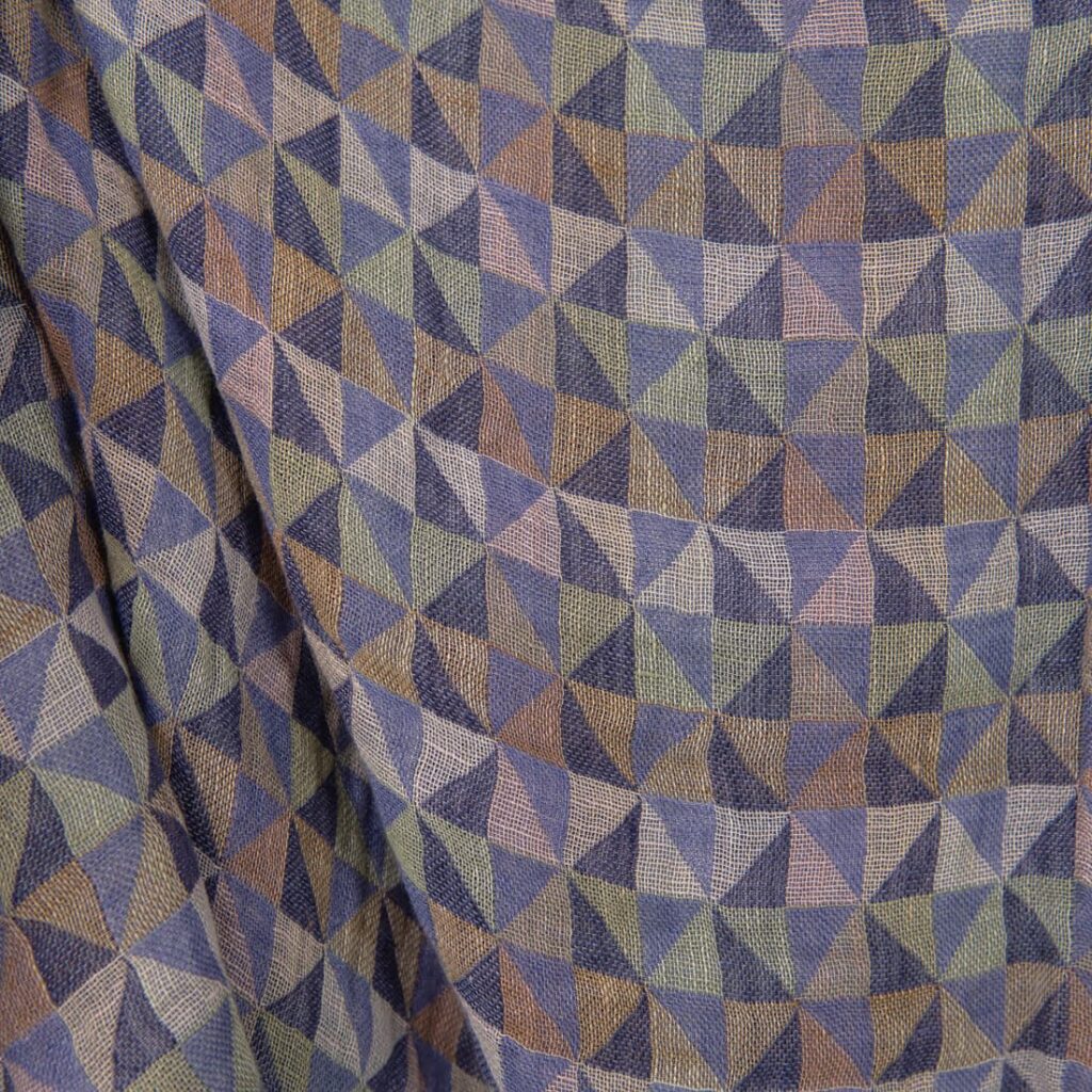 Washed linen fabric in violet multicolour triangles close up detail