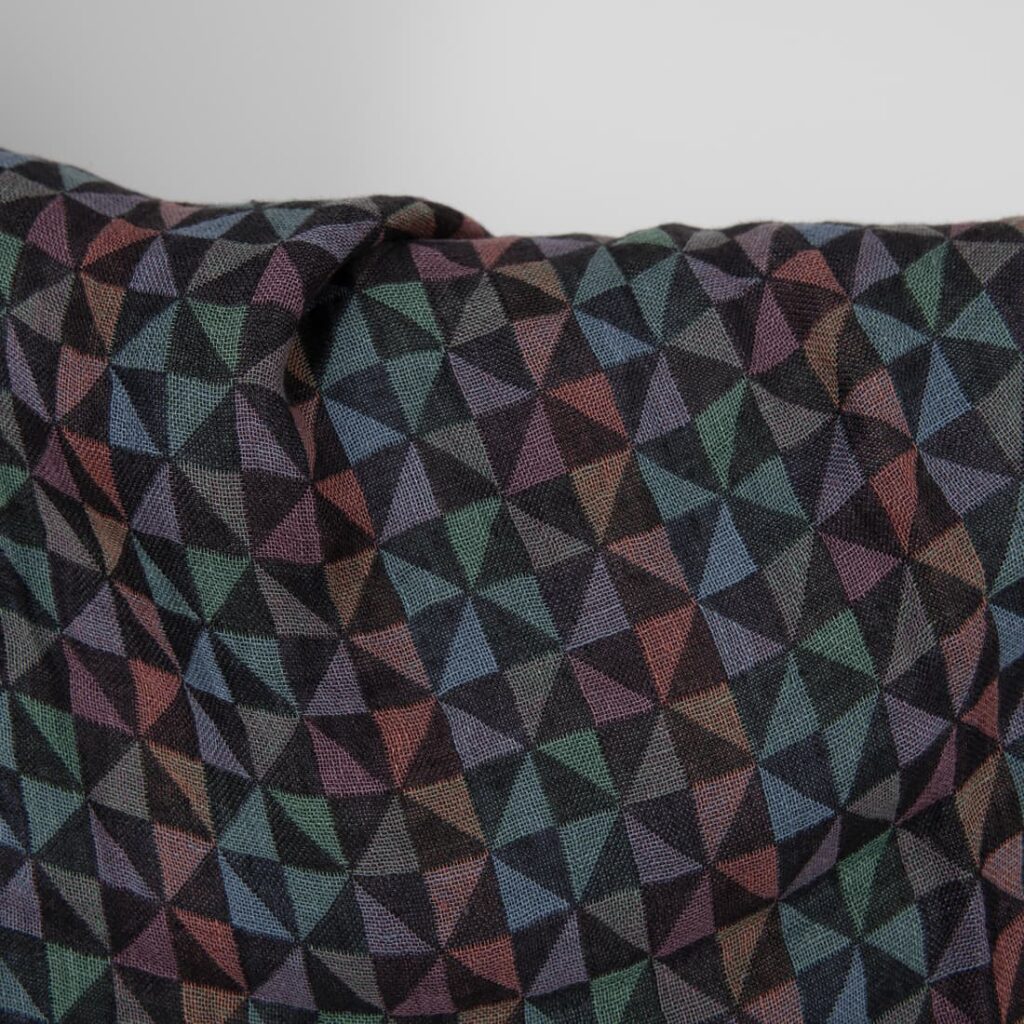 Washed linen fabric black with multicolour triangles close up detail