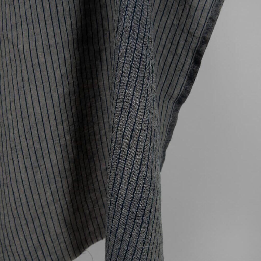 Washed linen fabric grey with thin black stripes edge
