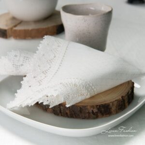 White colored linen napkin with hole pattern.