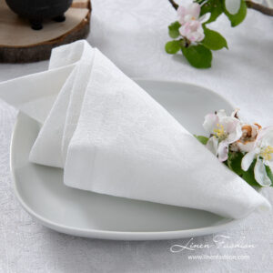 White linen napkin with flower ornaments