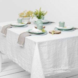 Off white linen tablecloth with loose fringes, washed
