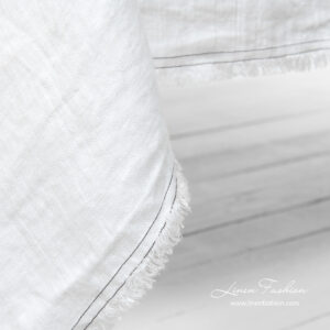 White tablecloth with fringes and double stitches