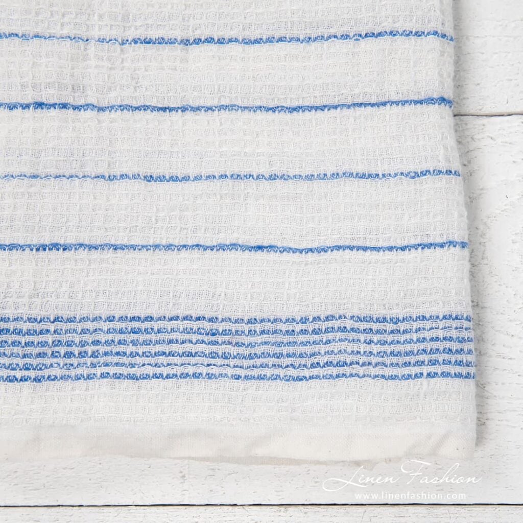 White kitchen towel with blue stripes, waffle weave