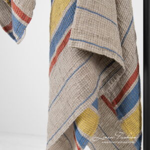 Linen cotton beige bath towel with yellow, blue, red stripes.