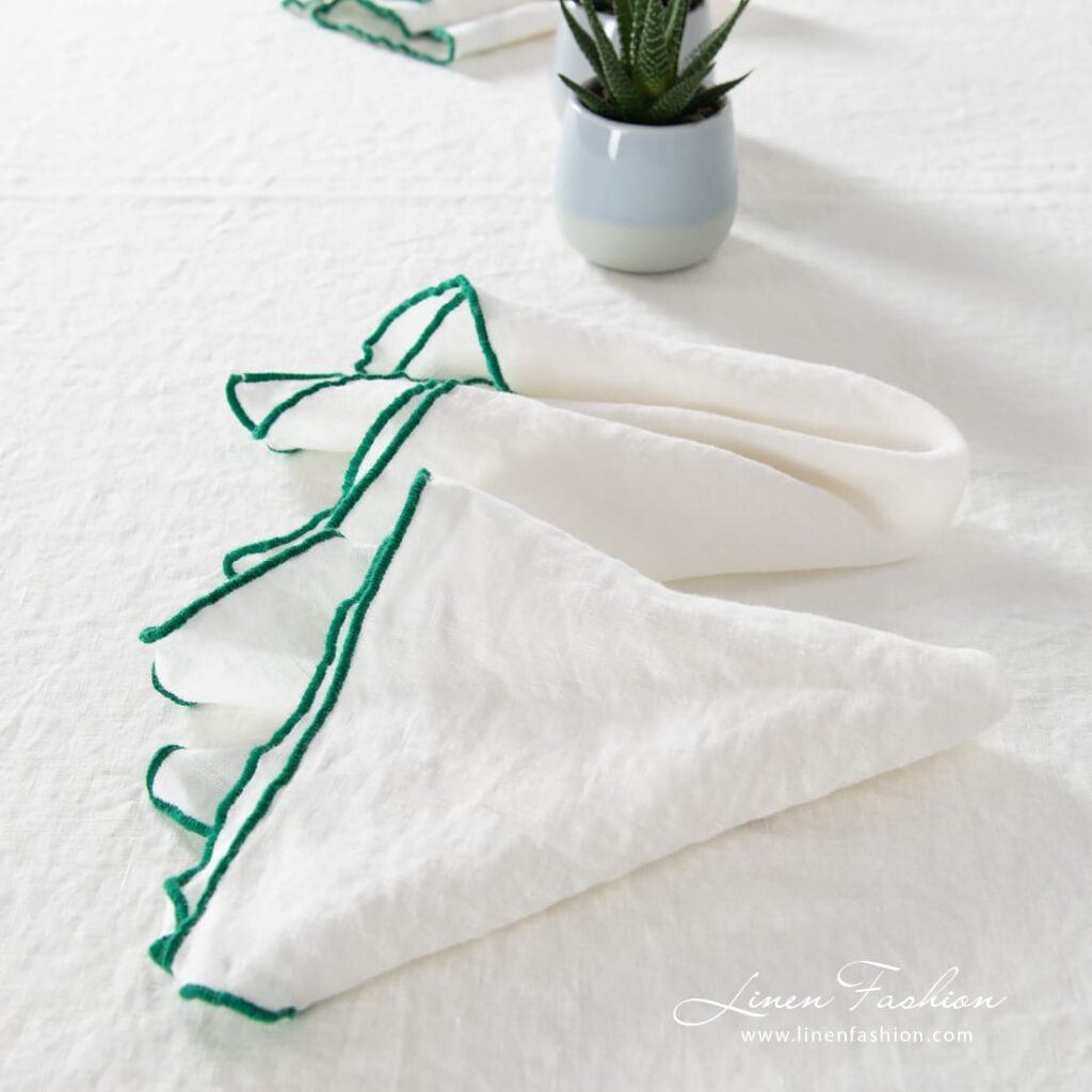 ARVO white linen napkin with bright green border