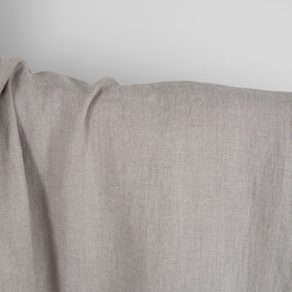 Washed linen fabric in natural grey close up detail