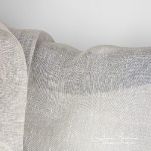 Transparent, lightweight light grey 100% linen fabric woven in a gauze pattern from natural flax grey and optical white yarns