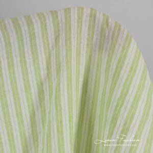 Light green linen fabric in stripes, washed