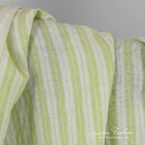 Light green linen fabric in stripes, specially washed to increase softness
