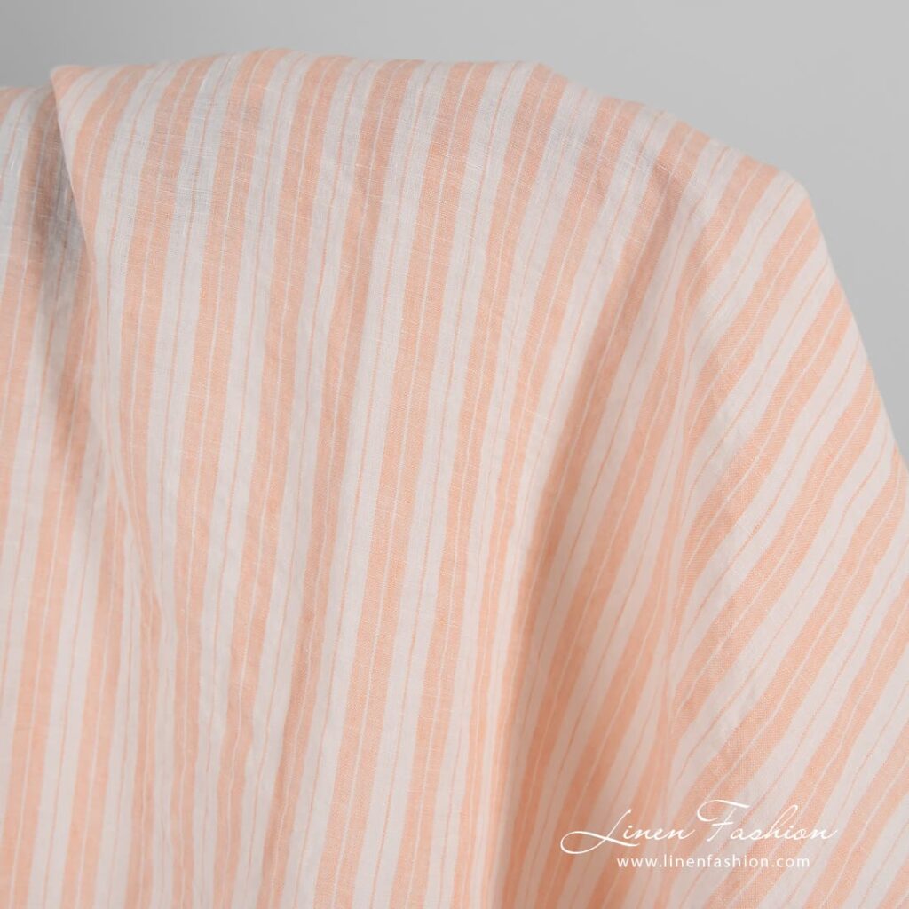 Striped linen fabric in peach color, washed