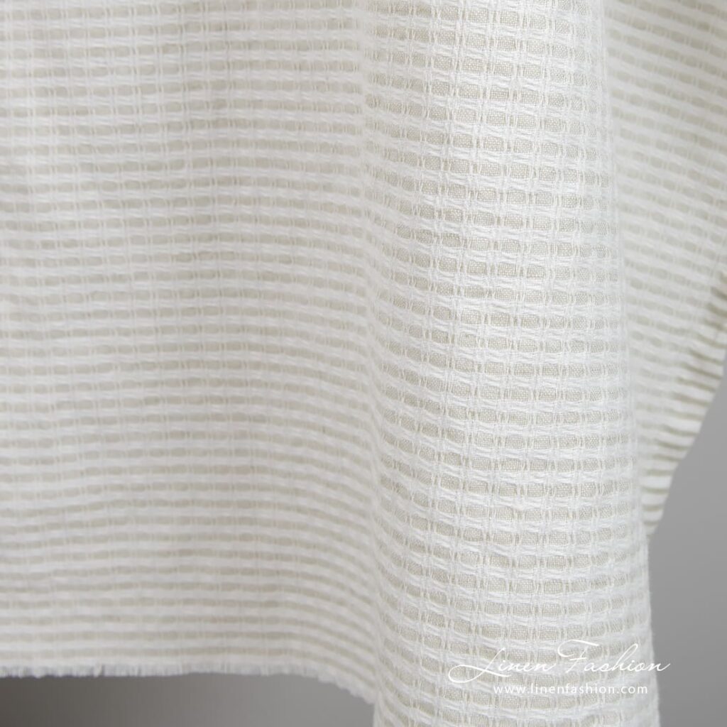 Light grey linen cotton fabric in checks, specially washed to increase softness