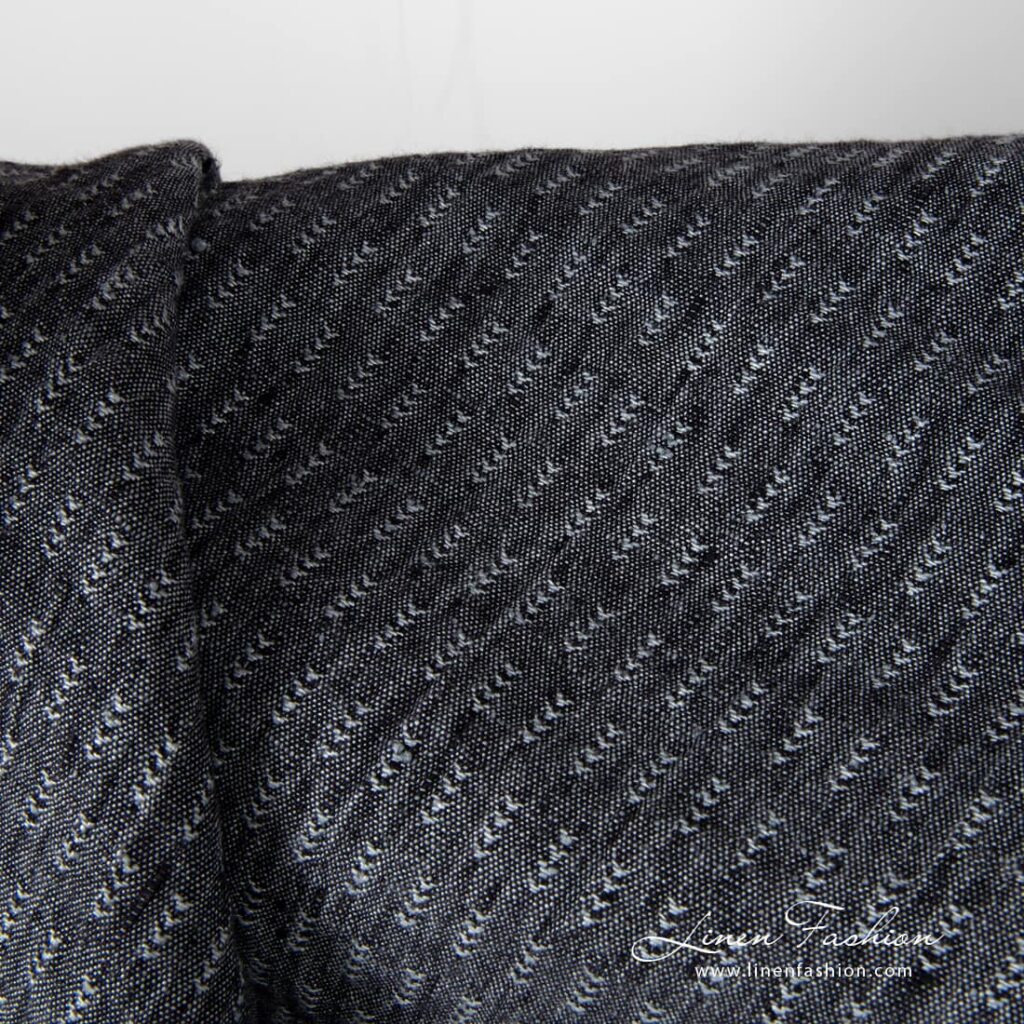 Closer view of black and grey tick pattern linen fabric, washed