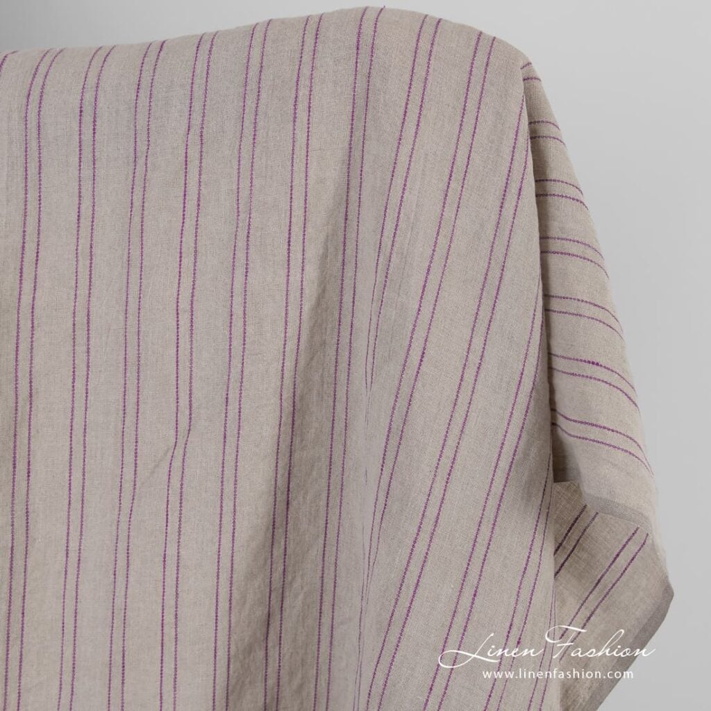 Natural color linen fabric in violet stripes, washed