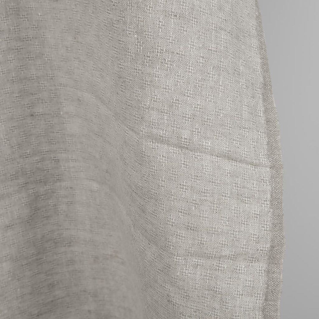 Openwork patterned linen fabric in beige edge