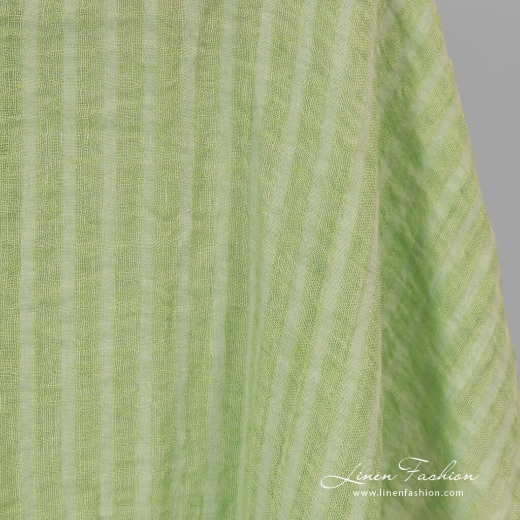 Washed 100% linen fabric in lime green stripes.