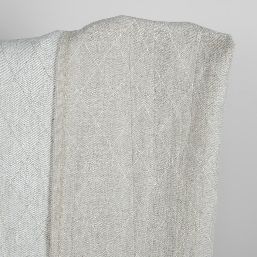 Grey double-sided washed linen fabric with a pattern darker side