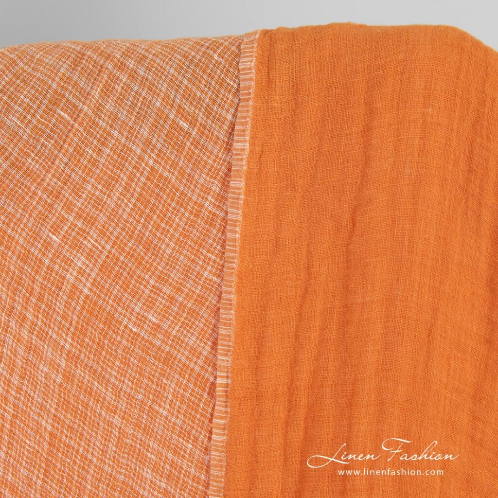 Double-sided orange linen fabric in checks, washed