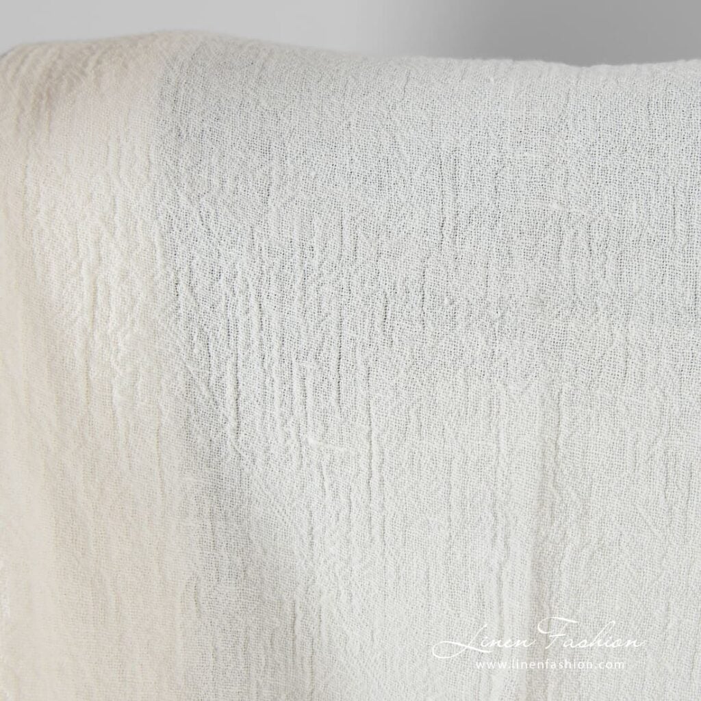 Linen fabric in off-white color, plain weave pattern