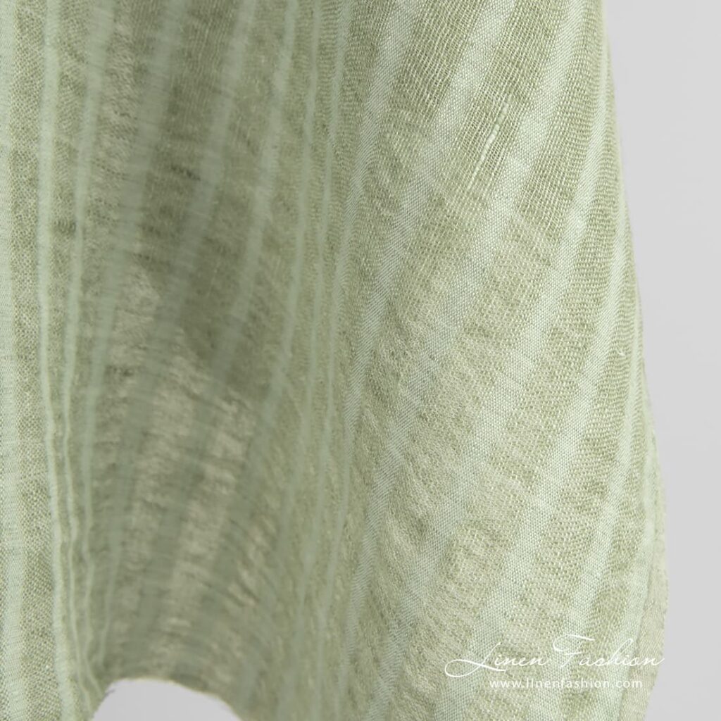 Green linen fabric in transparent vertical stripes