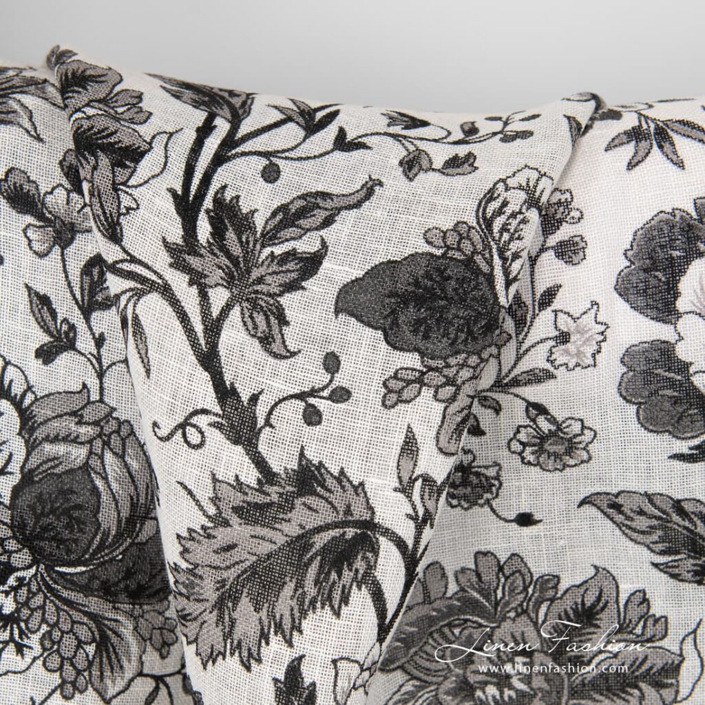 100% linen fabric decorated with black flowers.