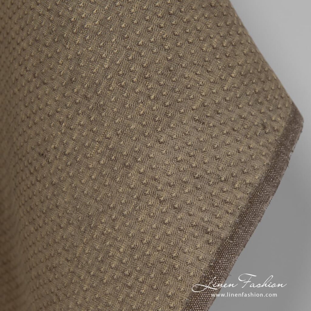 100% linen fabric in brown colour with spots.