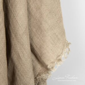 Brownish grey colored scarf of linen fabric.
